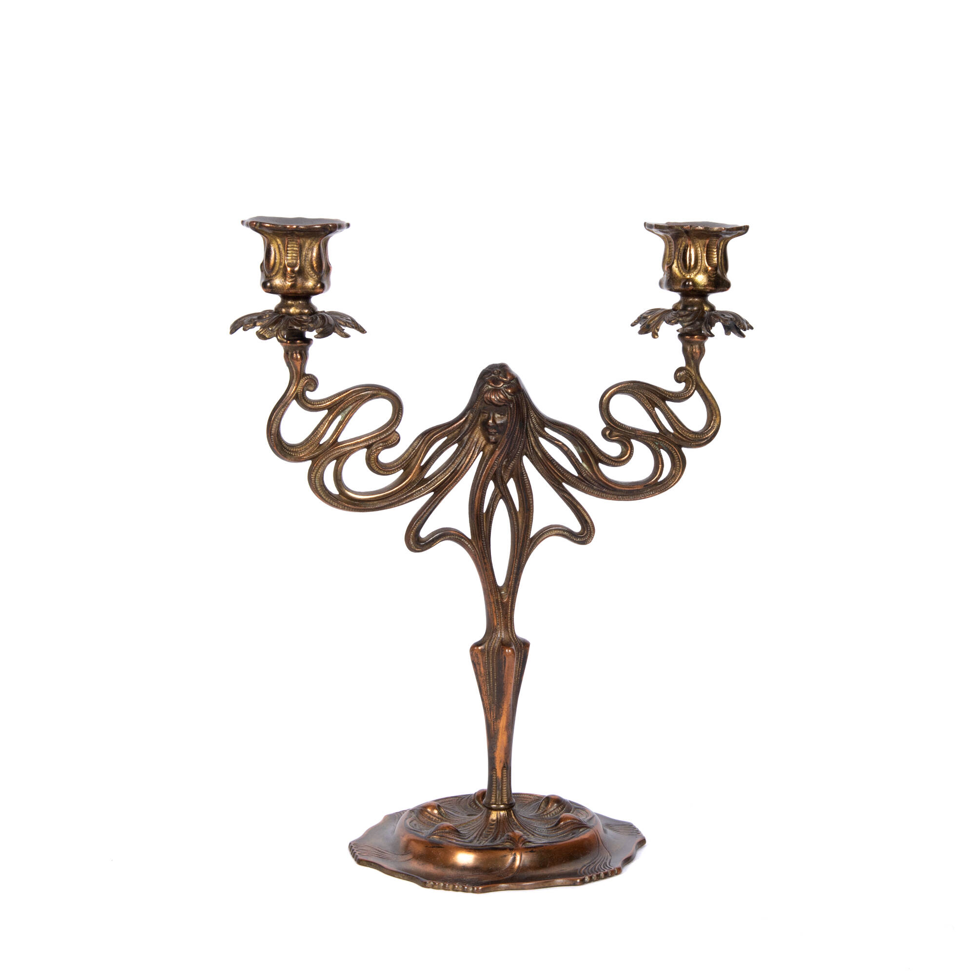 Brass two light candleholder. The base of the candleholder is round, and textures. The candlestick widens at the middle, and splits into several weaving lines.